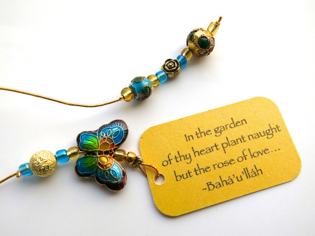 Turquoise butterfly cloisonne beaded bookmark with quote 'In the garden...'